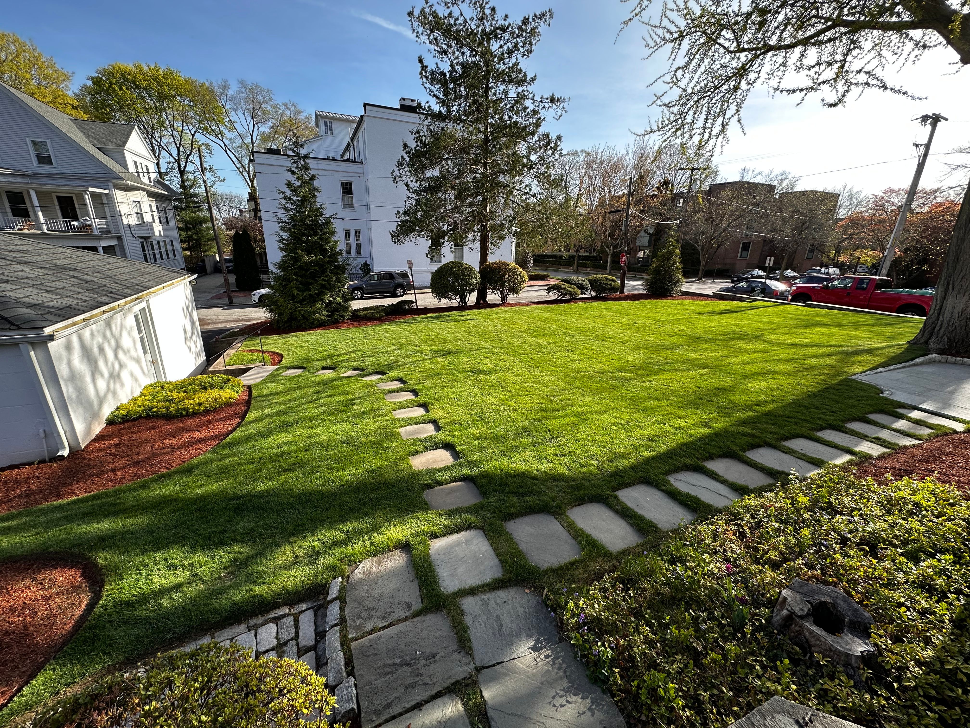 Newly installed planting beds with fresh mulch and clean edges on a Cranston home